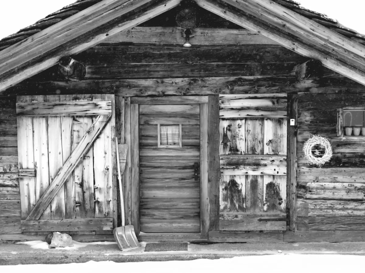 Verschneite Holzhütte in Schwarz-Weiß