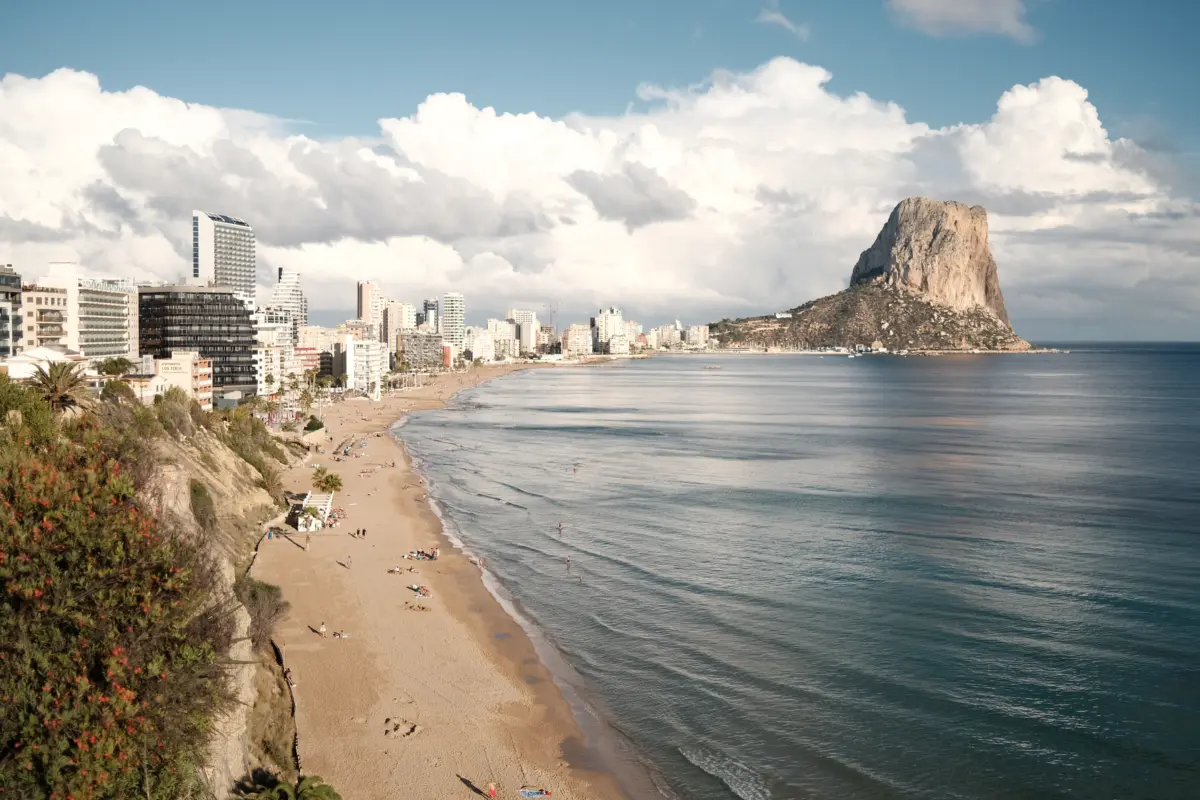 Langer Stadtstrand mit Hochhäusern und dem Peñón de Ifach